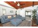Comfortable living room with a large sectional sofa, wood-paneled ceiling, and seamless access to the patio at 1529 Ensenada Dr, Orlando, FL 32825