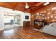 Cozy living room with wood flooring, vaulted ceiling, and sliding glass doors that lead to the backyard patio at 1529 Ensenada Dr, Orlando, FL 32825