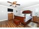 Comfortable primary bedroom features a ceiling fan, hardwood floors, and ample closet space at 1529 Ensenada Dr, Orlando, FL 32825