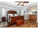 Spacious main bedroom with wood floors, stylish furniture, and a connecting bathroom at 1529 Ensenada Dr, Orlando, FL 32825