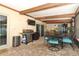 Covered patio includes a grill, television, dining table, and brick flooring at 1529 Ensenada Dr, Orlando, FL 32825