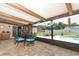 Enclosed patio features a table, seating, and a view of the lawn and pool area at 1529 Ensenada Dr, Orlando, FL 32825