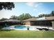 Backyard features a beautiful pool area with lounge chairs and lush greenery at 1529 Ensenada Dr, Orlando, FL 32825