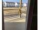 View from unfinished balcony overlooking the community and adjacent road and black fence at 15447 Hamlin Park Drive, Winter Garden, FL 34787