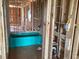 Vibrant blue bathtub installed during the home's construction phase, showcasing modern design elements at 15447 Hamlin Park Drive, Winter Garden, FL 34787