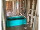 Vibrant blue bathtub installed during the home's construction phase, showcasing modern design elements at 15447 Hamlin Park Drive, Winter Garden, FL 34787