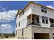 Exterior view of new construction home showcasing modern architecture and large windows at 15447 Hamlin Park Drive, Winter Garden, FL 34787