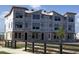 Exterior view of new townhomes being constructed with protective wrap and block foundation at 15447 Hamlin Park Drive, Winter Garden, FL 34787