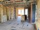 Spacious open-concept living room featuring exposed beams and abundant natural light during construction at 15447 Hamlin Park Drive, Winter Garden, FL 34787