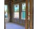 Interior view of new construction featuring framed walls, windows, and concrete block at 15447 Hamlin Park Drive, Winter Garden, FL 34787