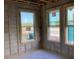 Interior view of new construction featuring framed walls, windows, and concrete block at 15447 Hamlin Park Drive, Winter Garden, FL 34787