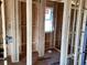 An unfinished room with exposed wooden beams and a single window lets in light at 15447 Hamlin Park Drive, Winter Garden, FL 34787
