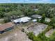 Aerial view of the property featuring the backyard, metal roof, and surrounding area at 160 Chestnut Ave, Orange City, FL 32763