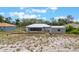 View of the backyard with screened porch, utility shed, and metal roof at 160 Chestnut Ave, Orange City, FL 32763