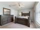 Serene bedroom featuring a wooden bed frame, dresser with mirror, and carpeted floors at 160 Chestnut Ave, Orange City, FL 32763