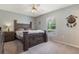 Relaxing bedroom with a wooden bed frame, a ceiling fan, and carpeted floors at 160 Chestnut Ave, Orange City, FL 32763