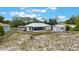 Backyard view featuring the home, screened-in patio, and detached storage shed at 160 Chestnut Ave, Orange City, FL 32763