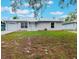 Charming single-story home featuring a metal roof, front lawn, one-car garage, and carport at 160 Chestnut Ave, Orange City, FL 32763