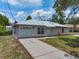 Charming single-story home with a well-maintained lawn, metal roof, a one-car garage, and a paved driveway at 160 Chestnut Ave, Orange City, FL 32763
