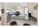 Kitchen boasts stainless appliances, eat-in bar, and view into dining area with wooden table set at 160 Chestnut Ave, Orange City, FL 32763