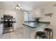 Bright kitchen featuring stainless steel appliances, white cabinets, and a breakfast bar at 160 Chestnut Ave, Orange City, FL 32763