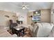 Inviting living room with neutral tones, tile flooring, ceiling fan, and large windows providing ample natural light at 160 Chestnut Ave, Orange City, FL 32763