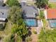 Aerial shot of the property featuring a screened-in pool and lush landscaping at 1633 Pinehurst Dr, Casselberry, FL 32707