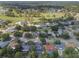Gorgeous aerial view showcasing the neighborhood's mature trees, expansive lawns, and scenic water features at 1633 Pinehurst Dr, Casselberry, FL 32707