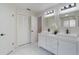Elegant bathroom boasts double vanity, black fixtures, and marble floors and accents at 1633 Pinehurst Dr, Casselberry, FL 32707