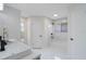 Elegant bathroom with white marble and tile, and black accents in the shower and vanity at 1633 Pinehurst Dr, Casselberry, FL 32707