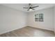 Clean, simply decorated bedroom with wood floors, modern fan, and large window at 1633 Pinehurst Dr, Casselberry, FL 32707