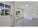 Bright entryway with gray wood floors, fresh paint, and a view to the outside through a large window at 1633 Pinehurst Dr, Casselberry, FL 32707