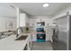 Bright kitchen boasts stainless steel appliances, white cabinets, and sleek countertops for a modern look at 1633 Pinehurst Dr, Casselberry, FL 32707