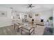 An open living room with a breakfast bar and gray wood floors connects seamlessly to the kitchen and dining area at 1633 Pinehurst Dr, Casselberry, FL 32707