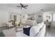 The open living room seamlessly connects to the kitchen and dining area with gray floors at 1633 Pinehurst Dr, Casselberry, FL 32707