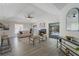 Open living room with fireplace, gray wood floors, and sliding glass doors leading to the backyard and pool at 1633 Pinehurst Dr, Casselberry, FL 32707