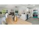 Open-concept living and kitchen area featuring modern white cabinets and a fireplace, perfect for entertaining at 1633 Pinehurst Dr, Casselberry, FL 32707