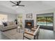 Spacious living room featuring a cozy fireplace and sliding glass doors opening to a refreshing pool area at 1633 Pinehurst Dr, Casselberry, FL 32707