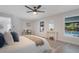 Comfortable main bedroom featuring a window with pool view and a ceiling fan at 1633 Pinehurst Dr, Casselberry, FL 32707