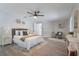 Bright and airy main bedroom with neutral decor, ceiling fan, and ample space for relaxation at 1633 Pinehurst Dr, Casselberry, FL 32707