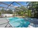 View of the sparkling pool and hot tub inside screened enclosure at 1633 Pinehurst Dr, Casselberry, FL 32707