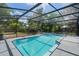 View of the sparkling pool and hot tub inside screened enclosure at 1633 Pinehurst Dr, Casselberry, FL 32707