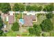 Aerial view of property featuring main house, guest house, swimming pool, mature trees, and lush green landscaping at 19123 Sheldon St, Orlando, FL 32833