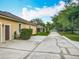 Backyard view of home with long driveway, lush landscaping, and well-maintained lawn at 19123 Sheldon St, Orlando, FL 32833