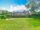Backyard view of home with manicured lawn and screened-in pool at 19123 Sheldon St, Orlando, FL 32833