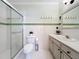 This full bathroom boasts a toilet, vanity, shower, and mint-colored decor at 19123 Sheldon St, Orlando, FL 32833