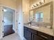 Stylish bathroom with granite countertop vanity and a view to the connecting room at 19123 Sheldon St, Orlando, FL 32833