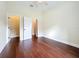 Spacious bedroom with hardwood floors, two doorways, and ceiling fan at 19123 Sheldon St, Orlando, FL 32833