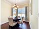 Dining area showcasing dark wood floors and a view of the outdoor pool through large windows at 19123 Sheldon St, Orlando, FL 32833