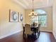 An elegant dining room featuring a dark wood table, upholstered chairs, and a decorative chandelier at 19123 Sheldon St, Orlando, FL 32833